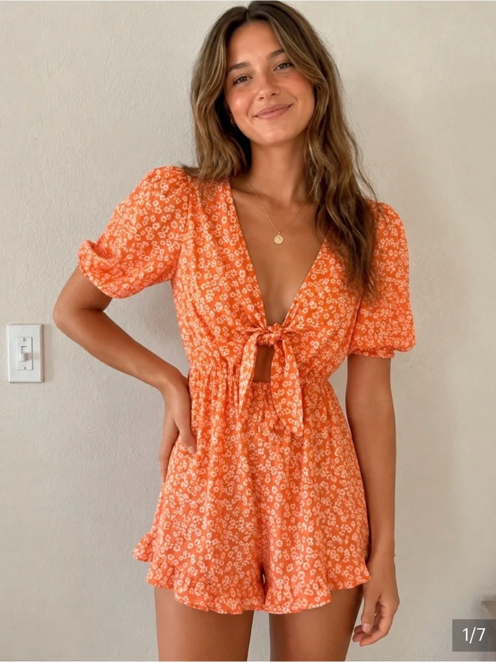 UO orange and white floral front-tie romper featuring short puff sleeves